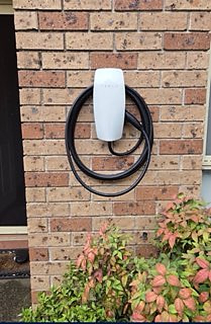 EV wall charger installed on brick