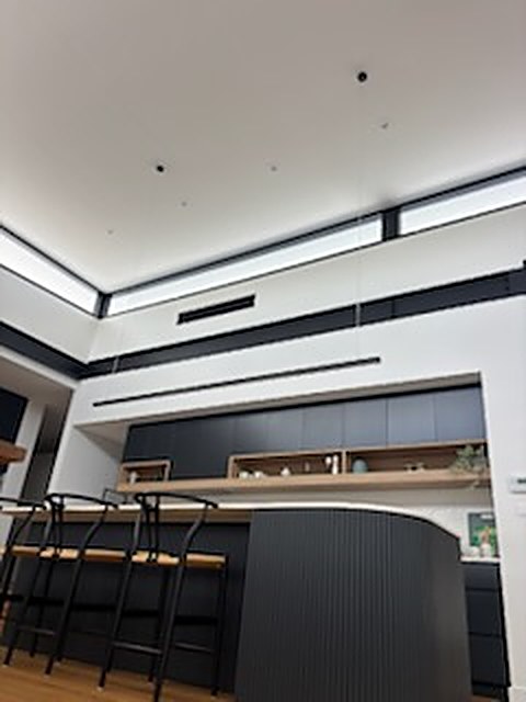 Architectural kitchen lighting with recessed strip and linear pendant
