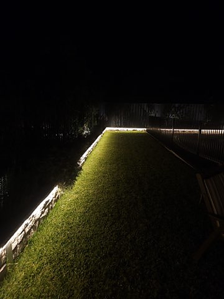 Garden wall-wash lighting at night